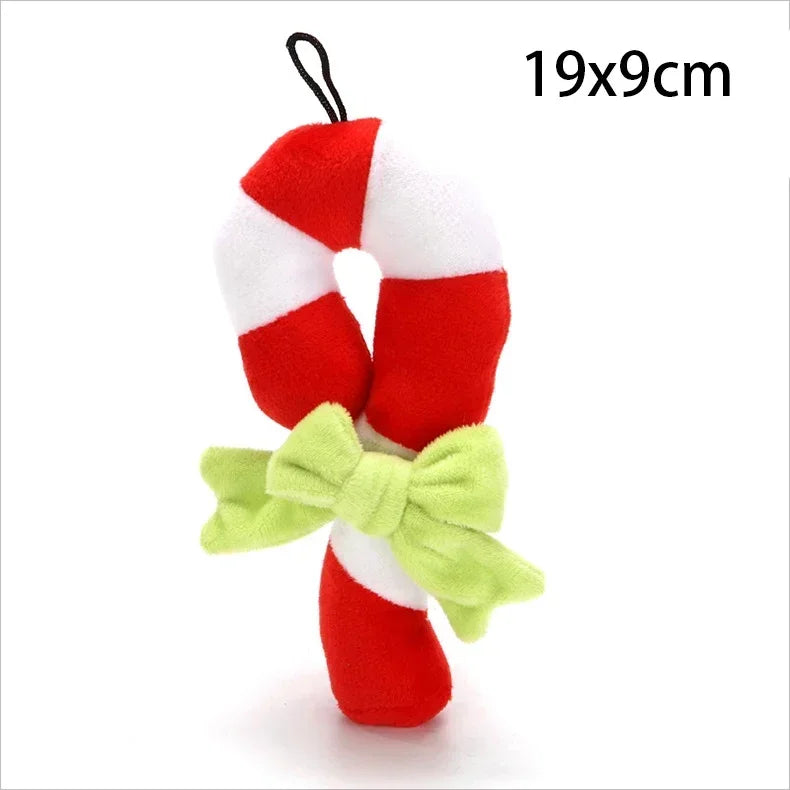 A small plush candy cane ornament or toy with red and white striped fabric and a light green bow