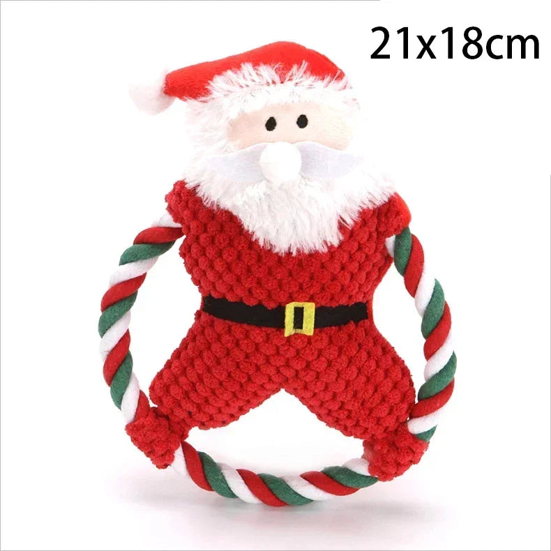 A plush Santa Claus dog toy with a red and white knitted body, white faux fur face and beard, red hat, black belt, and green-and-white rope handles